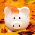 White,Ceramic,Piggy,Bank,With,Colorful,Autumn,Foliage