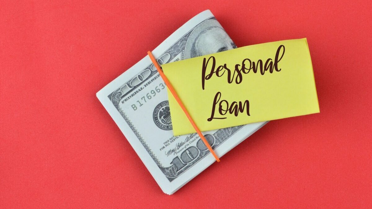 A note that says, “Personal Loan,” on top of bills