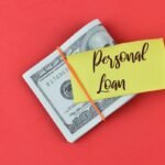 A note that says, “Personal Loan,” on top of bills