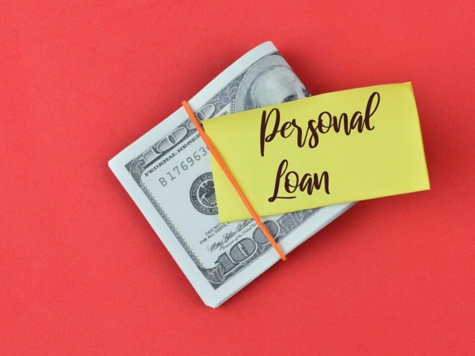 A note that says, “Personal Loan,” on top of bills