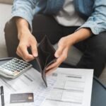 Person holding an empty wallet